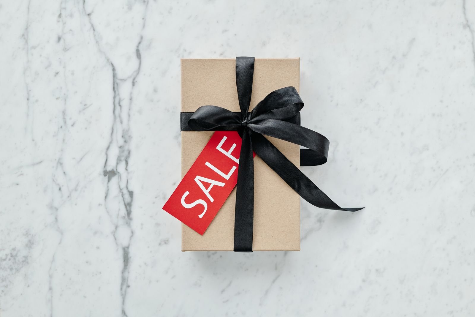 A gift box with a sale tag illustrates a targeted promotional offer.