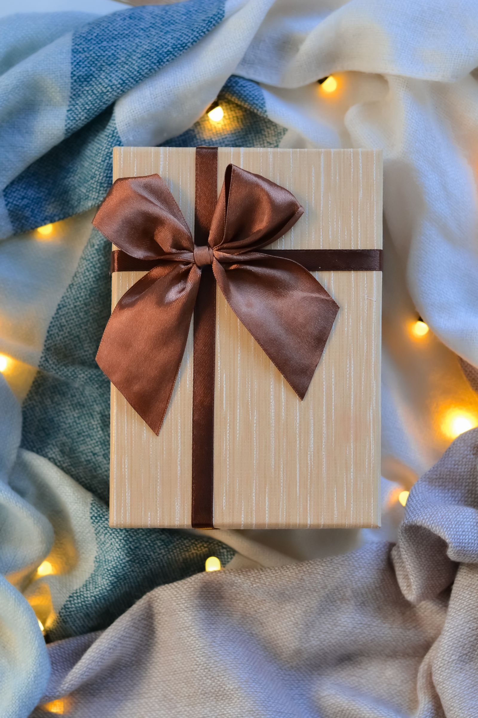 A wrapped gift box with ribbon illustrates gift giving for small businesses.
